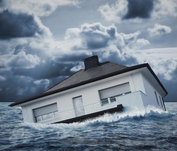 “a house floating in a large body of water"